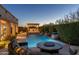 Inviting backyard pool with water features, fire pit, built-in grill, and comfortable seating area at 5512 E Barwick Dr, Cave Creek, AZ 85331