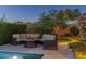 Inviting outdoor pool area with lush landscaping and comfortable patio seating around a fire pit at 5512 E Barwick Dr, Cave Creek, AZ 85331