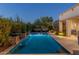 Tranquil swimming pool with serene lighting, water features and poolside seating at 5512 E Barwick Dr, Cave Creek, AZ 85331