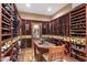 Spacious wine cellar with extensive custom wood shelving and a tasting table at 5512 E Barwick Dr, Cave Creek, AZ 85331
