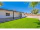 Backyard features a covered patio, artificial turf, gravel area, and block wall at 5534 W Calavar Rd, Glendale, AZ 85306