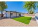 Spacious backyard features gravel landscaping, artificial turf, and a covered patio, perfect for outdoor living at 5534 W Calavar Rd, Glendale, AZ 85306