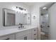 Modern bathroom features a sleek vanity with matte black fixtures and a large, framed mirror at 5534 W Calavar Rd, Glendale, AZ 85306