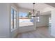 Sunny dining area with wood floors, stylish chandelier, and beautiful backyard view at 5534 W Calavar Rd, Glendale, AZ 85306
