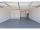 A two-car garage has painted walls and floor, with an electric door opener at 5534 W Calavar Rd, Glendale, AZ 85306