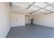Two car garage with painted walls and floor, and electric door opener at 5534 W Calavar Rd, Glendale, AZ 85306