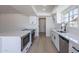 Well-lit kitchen with stainless steel appliances, white cabinetry, and sleek countertops at 5534 W Calavar Rd, Glendale, AZ 85306