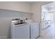 Convenient laundry area with modern washer and dryer units and ample shelving for storage at 5534 W Calavar Rd, Glendale, AZ 85306