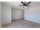 Bright, open living room with wood-look flooring and a ceiling fan at 5534 W Calavar Rd, Glendale, AZ 85306