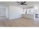Bright living room features wood floors, ceiling fan, and an open layout to the kitchen at 5534 W Calavar Rd, Glendale, AZ 85306