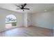 A living room with a contemporary arched window and modern wood-look flooring at 5534 W Calavar Rd, Glendale, AZ 85306