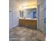 Bright bathroom showcasing a double sink vanity, ample counter space, and neutral tile flooring at 5952 W Morning Dove Dr, Glendale, AZ 85308