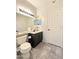 Bathroom with a dark vanity, large mirror, and light gray flooring at 5952 W Morning Dove Dr, Glendale, AZ 85308