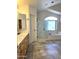 Well-lit bathroom featuring a soaking tub, glass shower, and a large vanity area at 5952 W Morning Dove Dr, Glendale, AZ 85308