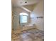 Bright bathroom features a soaking tub with a shower, tile flooring, and a window for natural light at 5952 W Morning Dove Dr, Glendale, AZ 85308