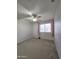 Bedroom with plush carpet, ceiling fan, and window with curtains at 5952 W Morning Dove Dr, Glendale, AZ 85308