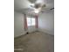 Bedroom with plush carpet, ceiling fan, and window with curtains at 5952 W Morning Dove Dr, Glendale, AZ 85308