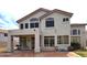 Back exterior view of home with patio and large windows at 5952 W Morning Dove Dr, Glendale, AZ 85308