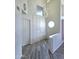 A bright foyer with gray wood floors and a modern lighting fixture at 5952 W Morning Dove Dr, Glendale, AZ 85308