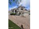 Charming two-story home with stucco exterior, red tile roof and green grass at 5952 W Morning Dove Dr, Glendale, AZ 85308