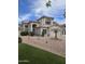 Charming two-story home with stucco exterior, red tile roof and green grass at 5952 W Morning Dove Dr, Glendale, AZ 85308