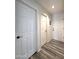 Hallway featuring multiple doors and wood-look flooring at 5952 W Morning Dove Dr, Glendale, AZ 85308