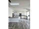 Well-lit kitchen with white cabinets, granite countertops, stainless steel appliances, and breakfast bar island at 5952 W Morning Dove Dr, Glendale, AZ 85308