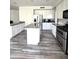 Bright kitchen with granite countertops, stainless steel appliances, and wood-look flooring at 5952 W Morning Dove Dr, Glendale, AZ 85308