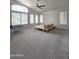 Spacious living room with carpet, lots of natural light and ceiling fan at 5952 W Morning Dove Dr, Glendale, AZ 85308