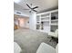Spacious living room features built-in shelving, fan, and neutral carpet at 5952 W Morning Dove Dr, Glendale, AZ 85308