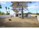 Large backyard with mature trees, covered patio, and privacy fence at 6 E Piping Rock Rd, Phoenix, AZ 85022