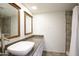 Bathroom featuring a vessel sink, granite countertop, and tiled shower at 6 E Piping Rock Rd, Phoenix, AZ 85022