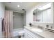 Well-lit bathroom with modern vanity and updated shower and bath featuring neutral, tasteful design at 6 E Piping Rock Rd, Phoenix, AZ 85022