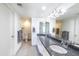 Updated bathroom featuring a dual sink vanity with granite countertops and tiled floors at 6 E Piping Rock Rd, Phoenix, AZ 85022