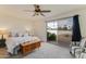 Comfortable primary bedroom featuring a ceiling fan and access to the outdoor space and backyard at 6 E Piping Rock Rd, Phoenix, AZ 85022