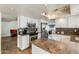 Bright open kitchen featuring granite countertops, stainless steel appliances, and a spacious layout at 6 E Piping Rock Rd, Phoenix, AZ 85022