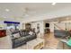 Expansive living room featuring wood-look floors, recessed lighting, and comfortable seating flowing into the dining area at 6 E Piping Rock Rd, Phoenix, AZ 85022