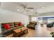 Large living room offers ceiling fans, recessed lights, wood-look floors, comfortable couches and plenty of space at 6 E Piping Rock Rd, Phoenix, AZ 85022