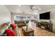 Spacious living room features wood-look floors, recessed lighting, ceiling fans, and comfortable seating at 6 E Piping Rock Rd, Phoenix, AZ 85022