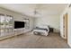 Spacious bedroom featuring carpet flooring, ceiling fan, and bright windows at 6 E Piping Rock Rd, Phoenix, AZ 85022