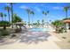 Community pool surrounded by palm trees and desert landscaping at 6 E Piping Rock Rd, Phoenix, AZ 85022