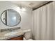 Clean bathroom with granite vanity, modern fixtures, and a framed mirror with white shower curtain at 623 W Guadalupe Rd # 213, Mesa, AZ 85210