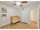 Bright bedroom with wood floors features a ceiling fan and a wooden crib at 623 W Guadalupe Rd # 213, Mesa, AZ 85210