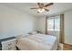 Comfortable bedroom with a large window, ceiling fan and two nightstands at 623 W Guadalupe Rd # 213, Mesa, AZ 85210