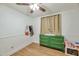 Bedroom with wood-look floors, decorative shelves, a changing table dresser and a ceiling fan, with natural light at 623 W Guadalupe Rd # 213, Mesa, AZ 85210