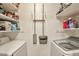 Well-organized laundry area featuring ample shelving and modern washer and dryer units for convenient household chores at 623 W Guadalupe Rd # 213, Mesa, AZ 85210