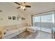 Bright living room features a large sectional couch and sliding doors to a private balcony with outdoor space at 623 W Guadalupe Rd # 213, Mesa, AZ 85210