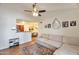 Cozy living room with hardwood floors, ceiling fan, and comfortable seating; adjacent to a modern kitchen and dining area at 623 W Guadalupe Rd # 213, Mesa, AZ 85210