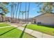 A tranquil community pool surrounded by palm trees and lush green grass at 623 W Guadalupe Rd # 213, Mesa, AZ 85210