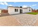 This backyard features fresh green turf, brick pavers, and gravel at 6332 W Sunnyslope Ln, Glendale, AZ 85302